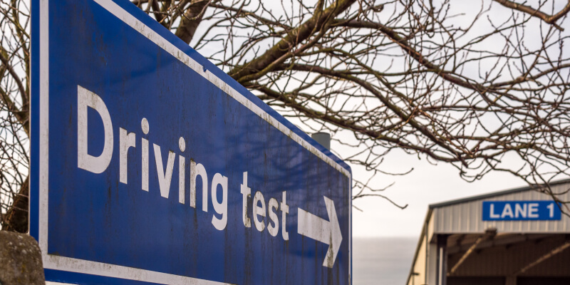 Sign with an arrow and the words: driving test